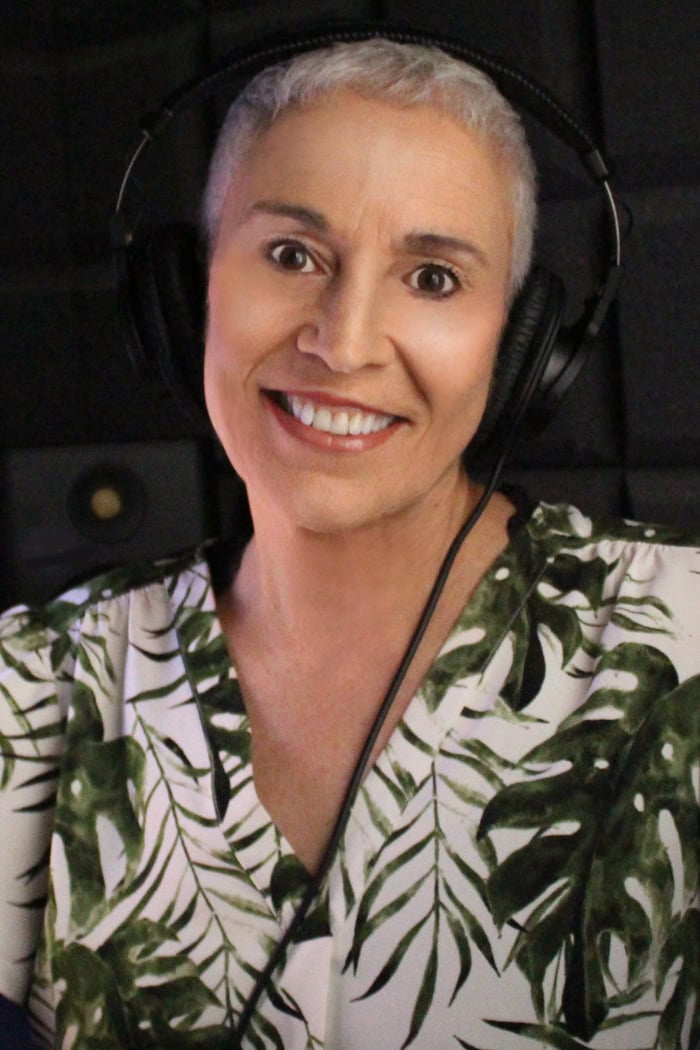 Colette in her sound booth smiling