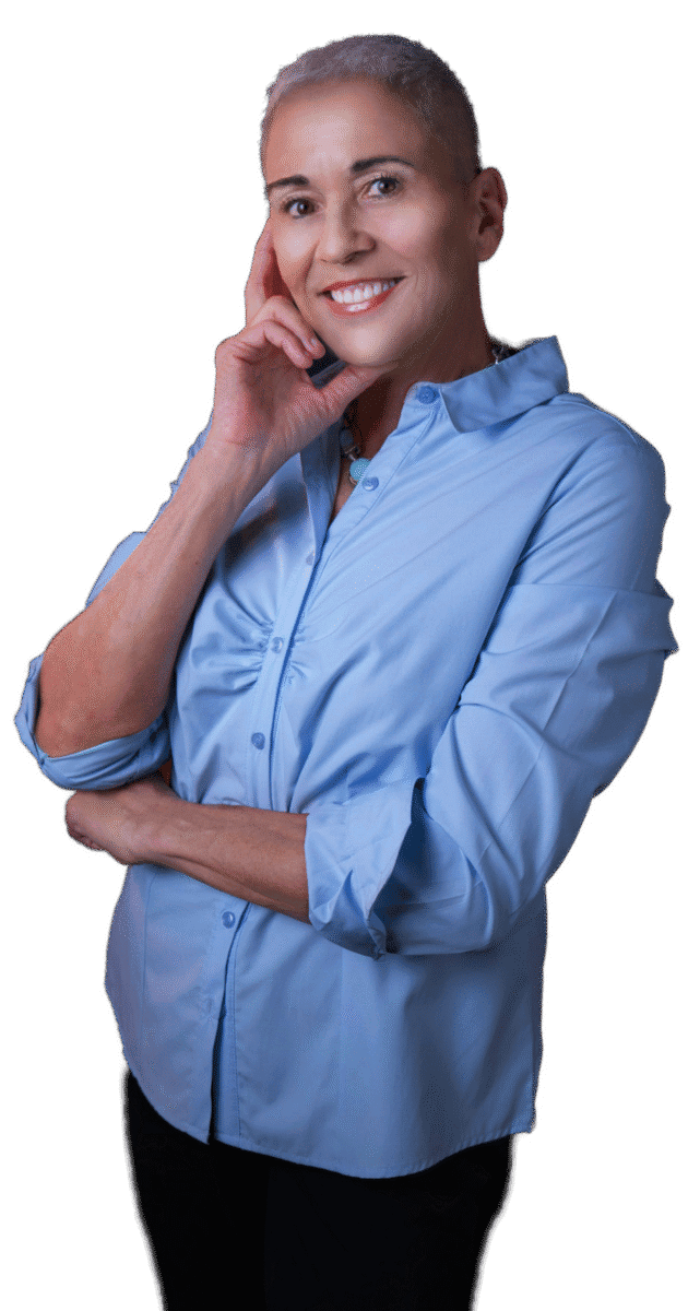 Colette standing wearing a blue shirt and black pants and with her chin resting on her hand